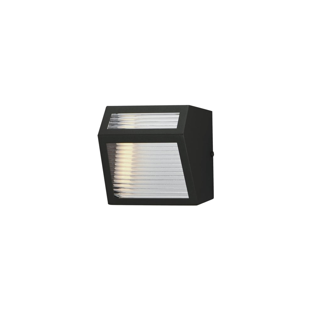 ET2 Totem Outdoor Wall Sconce in Black finish, made of Aluminum, mounted on a brick wall, casting a warm, inviting light.