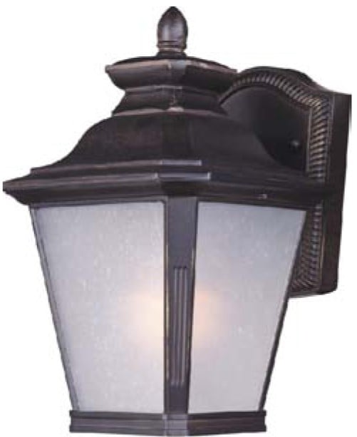 Maxim Lighting Knoxville Outdoor Wall Lantern in Bronze finish, crafted from Aluminum, mounted on a brick wall, illuminating a garden path.