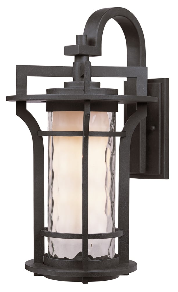 Maxim Lighting Oakville Outdoor Wall Light in Black Oxide finish, crafted from Aluminum, mounted on a brick wall, illuminating a garden path.