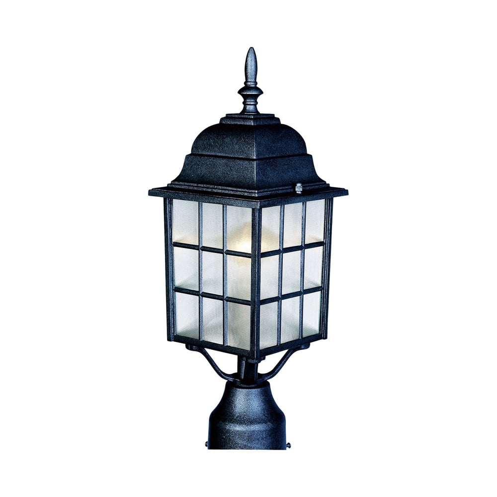 Maxim Lighting North Church Outdoor Post Light with a classic design, featuring a black finish and clear glass panels, illuminating a garden pathway.