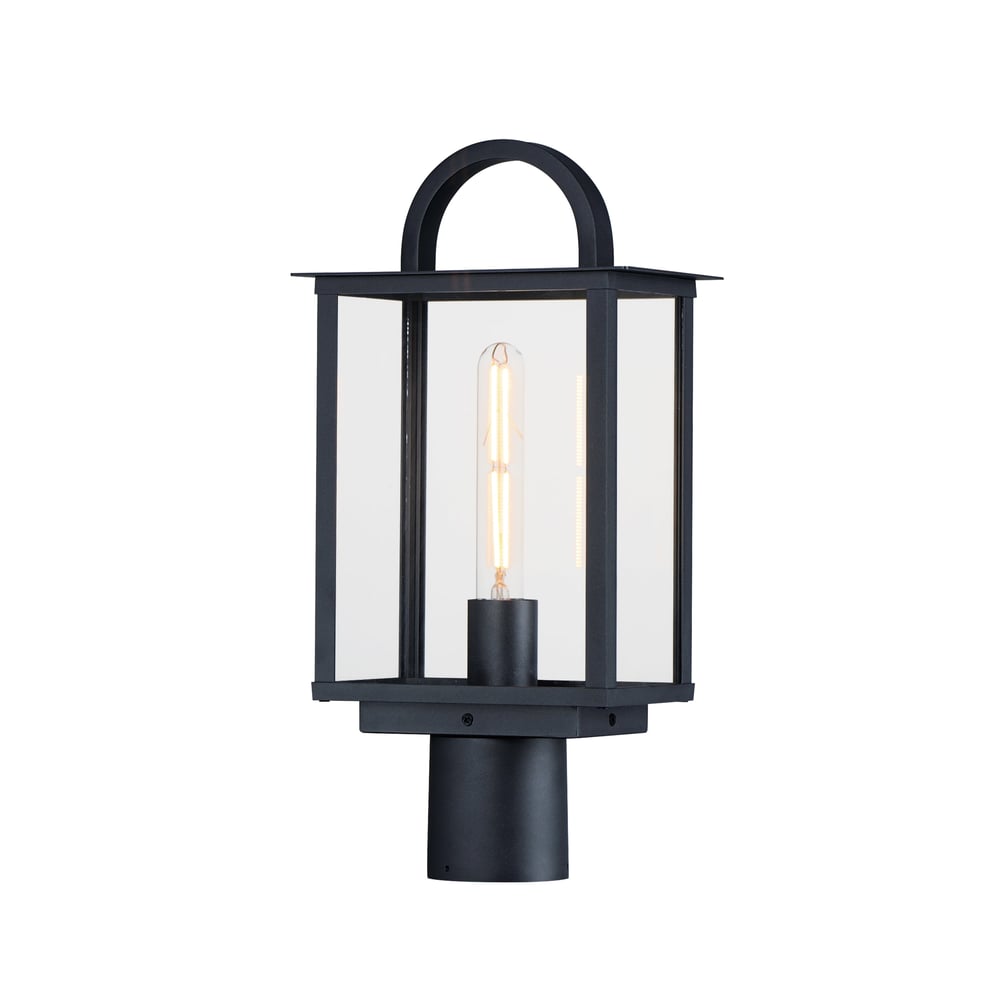 Maxim Lighting Manchester Outdoor Pier Light in Black finish, featuring an elegant Aluminum frame with clear Glass panels, illuminating a garden pathway.