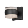 ET2 Modular Can Outdoor Wall Sconce in black aluminum finish, mounted on a brick wall, illuminating the area with soft, warm light.