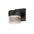 ET2 Modular Ribbed Can Outdoor Wall Sconce in black aluminum with glass panels, mounted on a wall, emitting a warm glow.