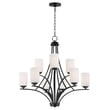 Maxim Lighting Deven Chandelier featuring a sleek black steel frame with elegant glass accents, suspended gracefully in a modern interior setting.
