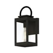 Maxim Lighting Nassau Vivex Outdoor Wall Sconce in black finish, featuring a steel frame with glass panels, elegantly illuminates an exterior wall.