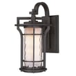 Maxim Lighting Oakville Outdoor Wall Light in Black Oxide finish, crafted from Aluminum, mounted on a brick wall, illuminating a garden path.