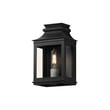 Maxim Lighting Savannah VX Outdoor Wall Sconce in Black Oxide finish, crafted from Aluminum, elegantly illuminates a garden path with a classic design.
