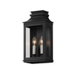 Maxim Lighting Savannah VX Outdoor Wall Sconce in Black Oxide finish, crafted from durable Aluminum, mounted on a brick wall, illuminating a garden path.