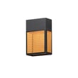 Maxim Lighting Lattice Outdoor Sconce in Black finish, featuring Aluminum and Synthetic Rattan design, mounted on a wall, casting a warm glow.