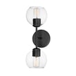 Maxim Lighting Knox Wall Sconce with a sleek black steel frame and clear glass shade, mounted on a wall, emitting soft ambient light.