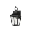 Maxim Lighting Storybook Outdoor Wall Sconce in Black Aluminum with Glass panels, featuring a classic lantern design mounted on a wall.