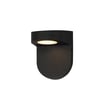Maxim Lighting Ledge Outdoor Wall Sconce in black aluminum with glass panels, mounted on a wall, illuminating a pathway with a modern design.