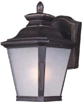 Maxim Lighting Knoxville Outdoor Wall Lantern in Bronze finish, crafted from Aluminum, mounted on a brick wall, illuminating a garden path.