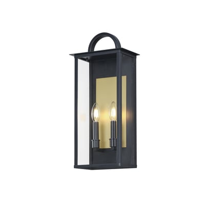 Maxim Lighting Manchester Outdoor Wall Sconce in black aluminum finish, featuring a classic design with a clear glass shade, mounted on an exterior wall.