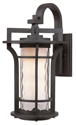 Maxim Lighting Oakville Outdoor Wall Light in Black Oxide finish, crafted from Aluminum, mounted on a brick wall, illuminating a garden path.