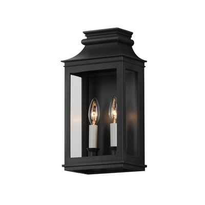 Maxim Lighting Savannah VX Outdoor Wall Sconce in Black Oxide finish, crafted from durable Aluminum, mounted on a brick wall, illuminating a garden path.