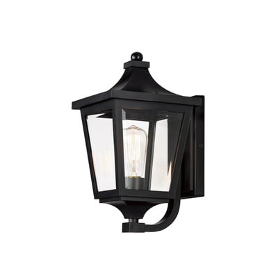 Maxim Lighting Sutton Place VX Outdoor Wall Sconce in Black finish, featuring a sleek Steel frame with clear Glass panels, mounted on an exterior wall.