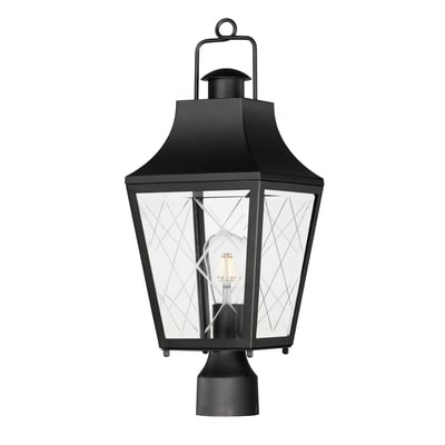 Maxim Lighting Storybook Outdoor Post in black finish, featuring an aluminum frame with glass panels, elegantly illuminates a garden pathway.