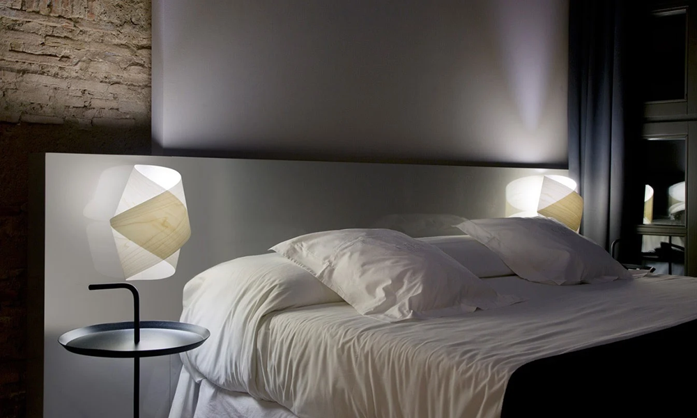 bedroom wall sconces providing reading lighting.